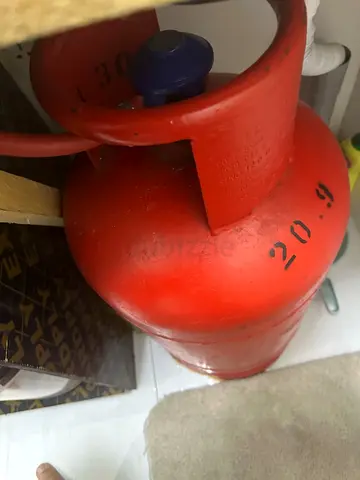 Red Gas cylinder with regulator and pipe