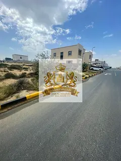 For sale in Sharjah, Al Hooshi area: Residential land plot, 20,000 sq ft, on an 18-meter paved road.