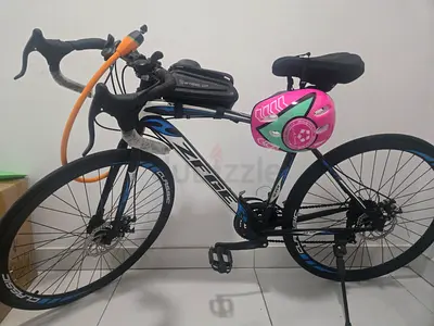 Road-style hybrid bicycle with child helmet — good condition