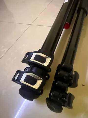Used lightweight camera tripod with quick-release leg locks