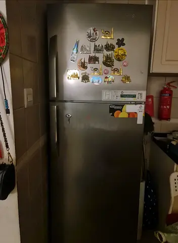 Used double-door refrigerator in good working condition - stainless steel finish