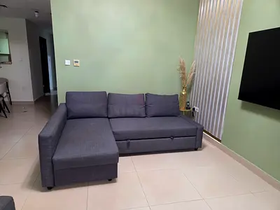 Grey L-shaped sectional sofa with pull-out bed