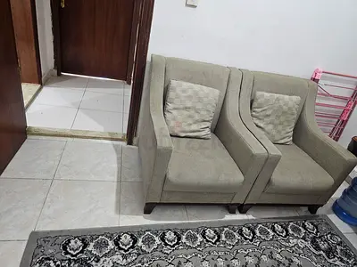 Pair of beige fabric single armchairs with cushions