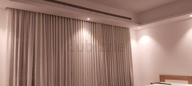 Floor-to-ceiling neutral fabric curtains with blackout lining - set of panels