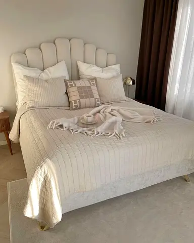 Beige upholstered double bed with scalloped headboard - good condition