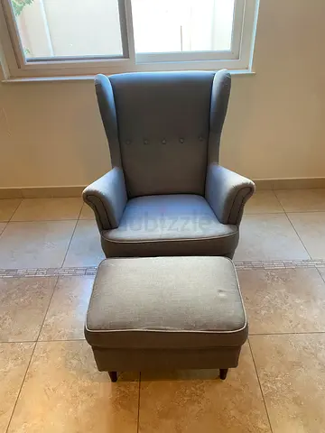 Comfortable grey wingback armchair with matching ottoman - good condition