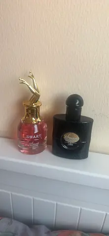 Two perfume bottles — Smart fragrances (one pink, one black) special discount two by 45 aed