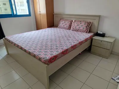 King size wooden bed frame with mattress and nightstand