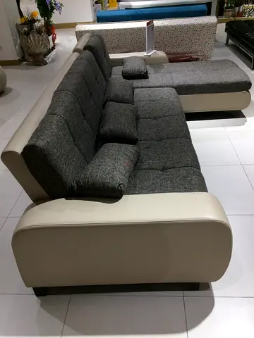 Grey fabric 4-seater sofa with cream leather arms and ottoman