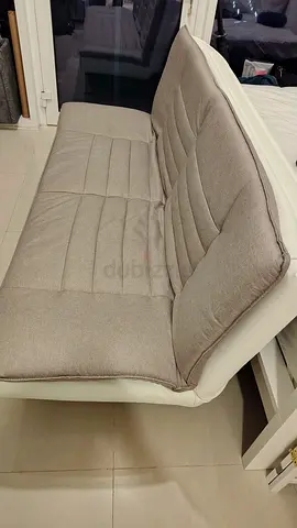 Compact 2-seater sofabed in beige fabric and white frame - good condition