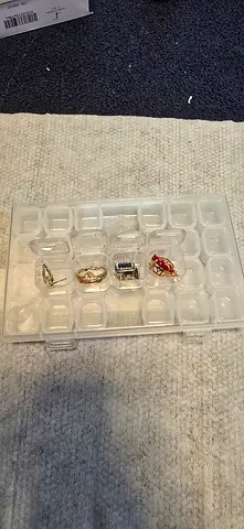 Collection of assorted rings (mens and womens) in storage case