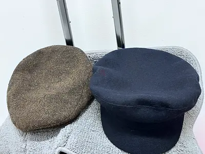 Two vintage-style flat caps / baker boy hats — brown tweed and navy