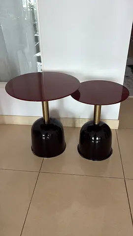 Pair of modern round side tables with glossy bases