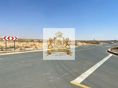 For sale in Sharjah Rawdat Al Qurt area Residential investment plot, 3,100 square feet, corner plot, on two adjacent streets