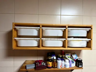 Wall-mounted wooden storage shelf with 6 plastic bins - used, good condition