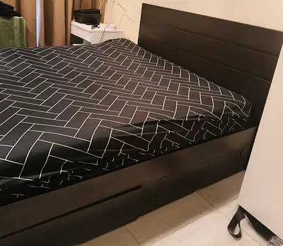 Dark wood queen bed frame with headboard and storage drawers