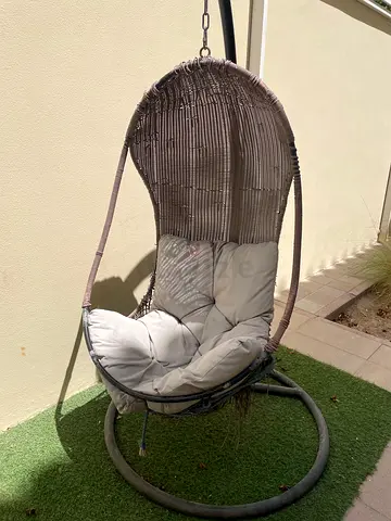 Hanging chair with gray cushion