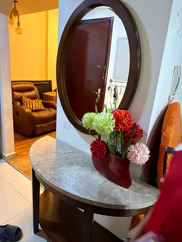 Round marble-top entry table with decorative vase