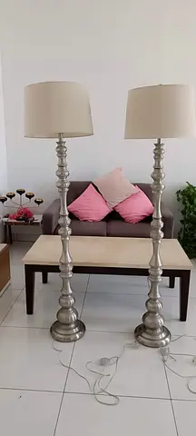 Pair of tall silver floor lamps with cream shades — good condition