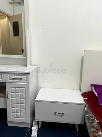 White bedside table and mirror table with chair