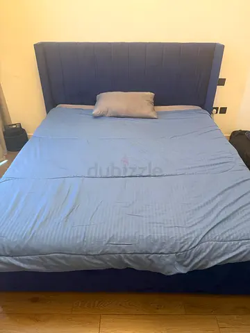 Blue upholstered double bed with padded headboard - good condition