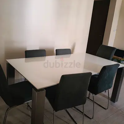Modern white glass dining table with 6 upholstered chairs