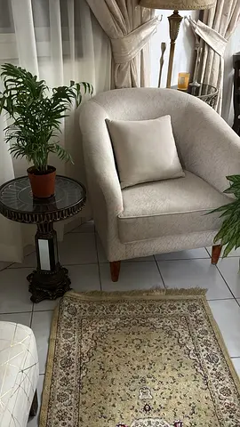 Light beige armchair with matching cushion — excellent condition