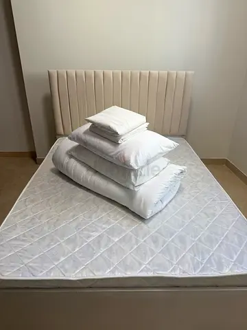 Queen bed frame with upholstered headboard and mattress