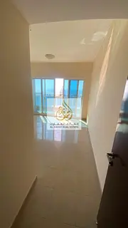 Two bedrooms and a large living room with a laundry room and built-in wardrobes, opposite Ajman Towe