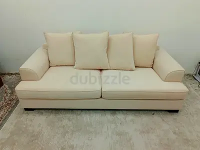 The one brand beige color three seater sofa