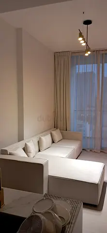 Light beige L-shaped modular corner sofa in good condition