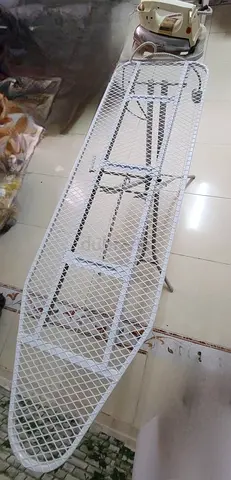 Ironing board with Adjustable height, sturdy metal mesh surface used.