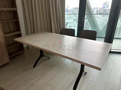 Modern rectangular West Elm dining table with wooden top and metal legs and 4 OC home chairs