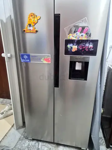 Side-by-side stainless steel refrigerator with water dispenser - used
