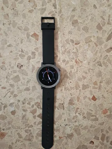 Used round smartwatch with black silicone strap