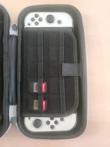 White Nintendo Switch Lite (with carry case and game cards 3 games with boxes) bought from Japan.