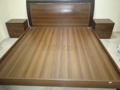 King-sized wooden bed frame with storage drawers with two matching bedside tables - good condition
