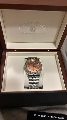 Wrist-sized mens stainless steel watch with rose gold dial in original box. Brand new.