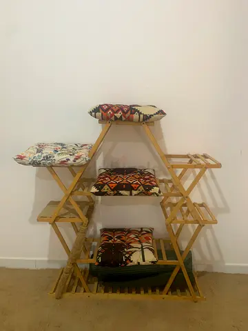 Wooden multi-tier plant/linen rack with cushions - good condition
