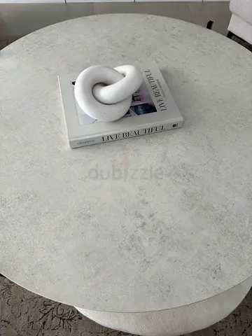 Round Coffee Table with Light Marble Finish and upholstered footstool