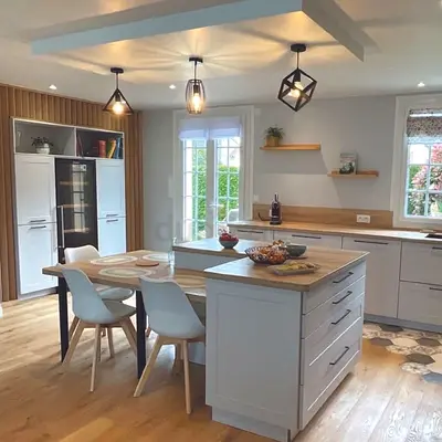 Modern white kitchen island with dining extension and storage