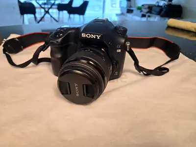 Sony Alpha A68 DSLR camera with lens and bag