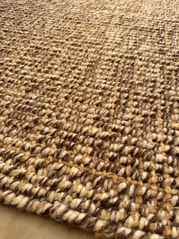 Woven wool rug in neutral beige and brown in good used condition
