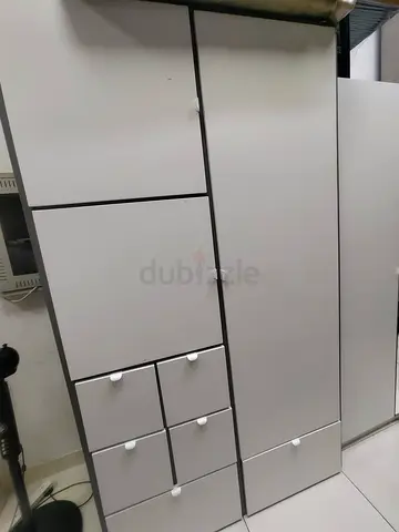 White freestanding wardrobe with multiple drawers and compartments