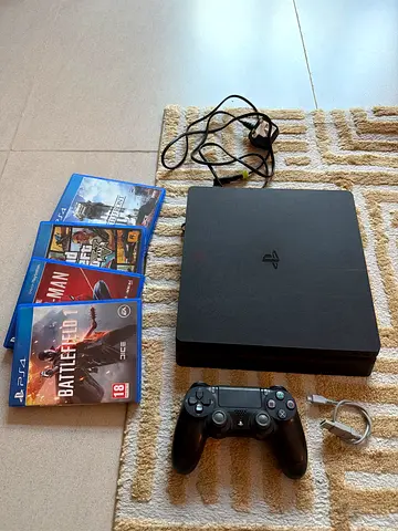 Sony PlayStation 4 Slim with controller, cables and 4 games -working condition fine