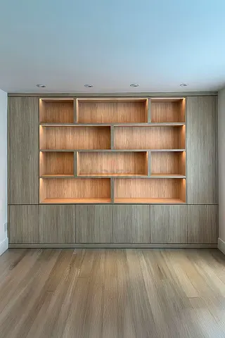 Custom Built-in Wooden Shelving Unit with Cabinet Base — Modern Finish