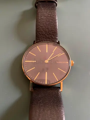 Classic mens wristwatch with brown leather strap and minimalist dial