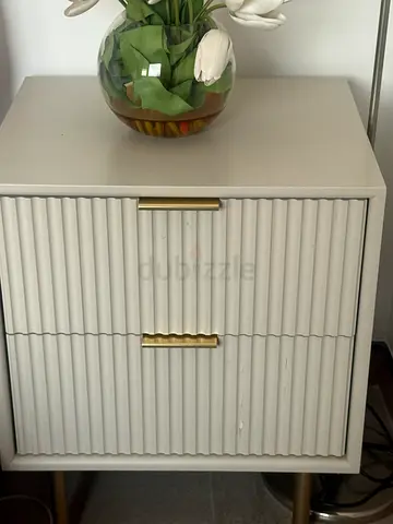 Light grey bedside table / nightstand with textured doors and brass handles
