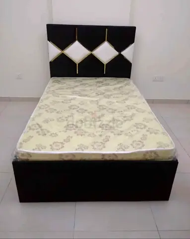 Double bed with mattress and upholstered headboard