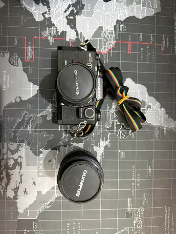 Olympus OM-D mirrorless camera with extra Olympus lens — well kept